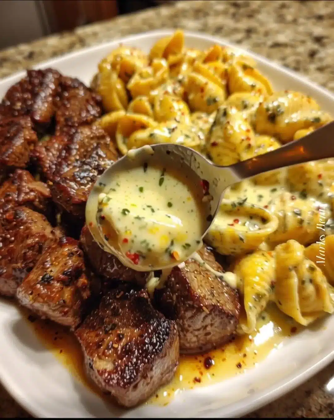 Garlic Butter Steak served with cheesy shells in cheddar sauce