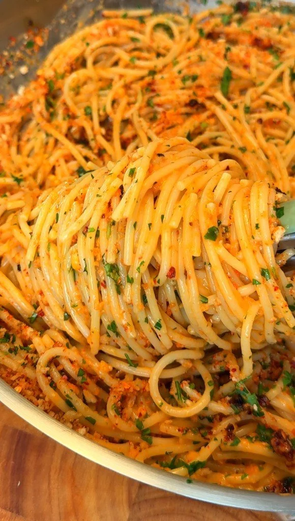 Delicious Garlic Butter Pasta served in a bowl with fresh herbs and parmesan cheese.